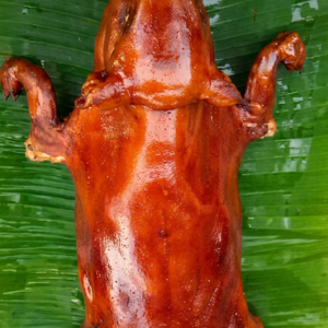 lechon cochinillo on top of fresh babana leaf