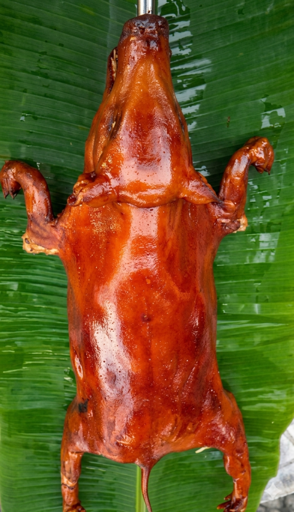 lechon cochinillo on top of fresh babana leaf